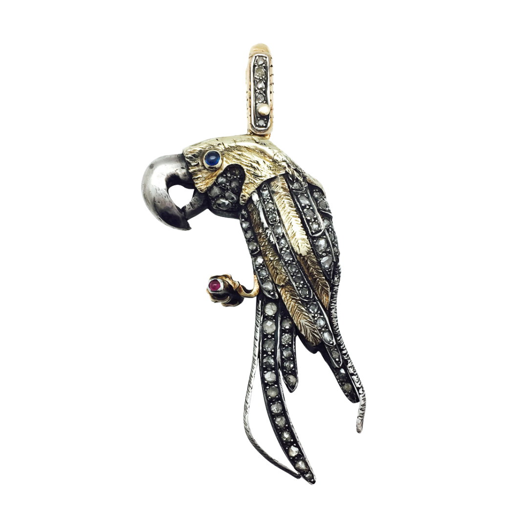 Colgante “Loro”, oro amarillo y plata.