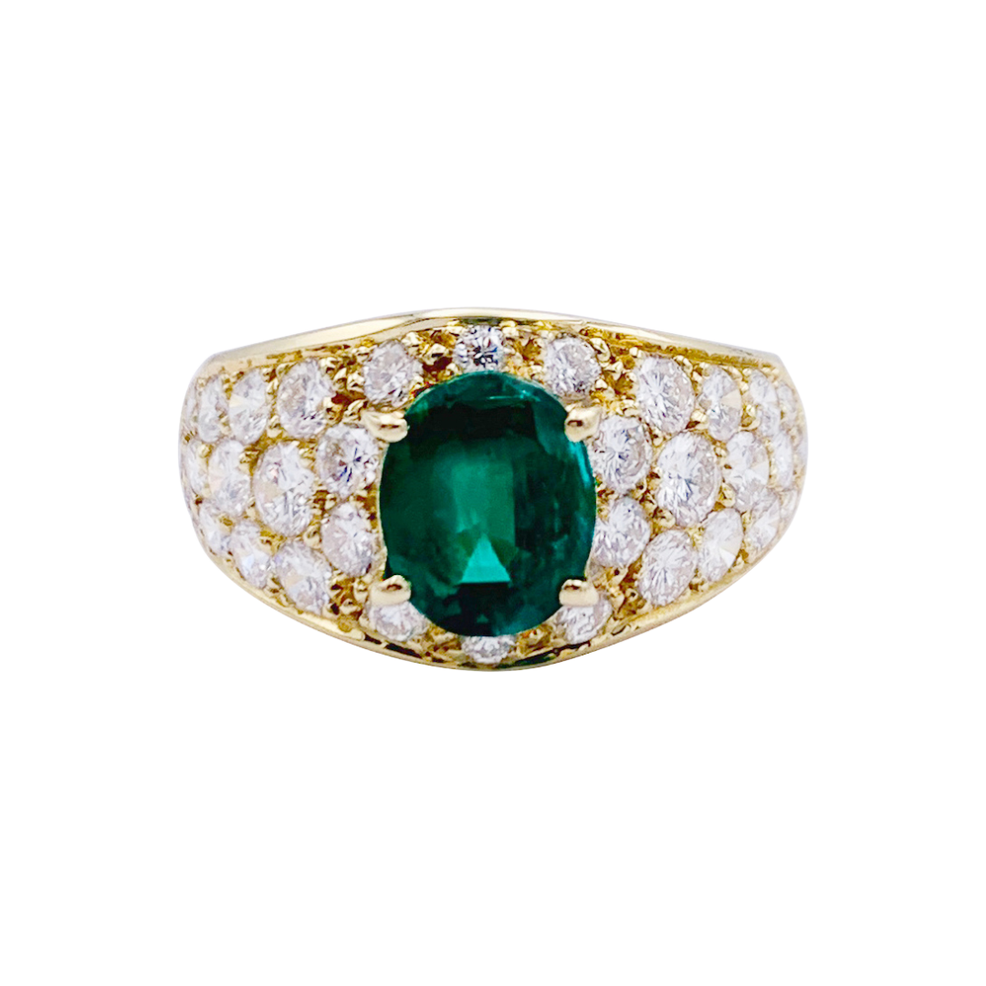 Bague or jaune, émeraude ovale et pavage diamants.
