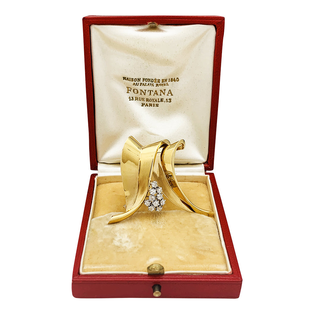 Broche Fontana en or jaune 750/000 et platine 950/000 sertie de 10 diamants taille ancienne. Poids brut : 11,4 grammes. 12