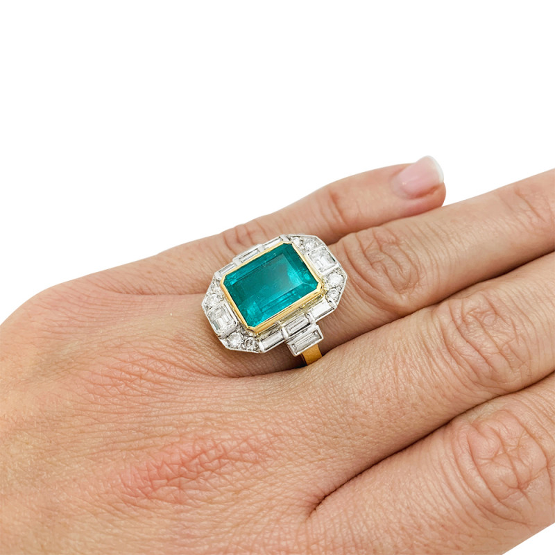 Two golds emerald ring, diamonds.